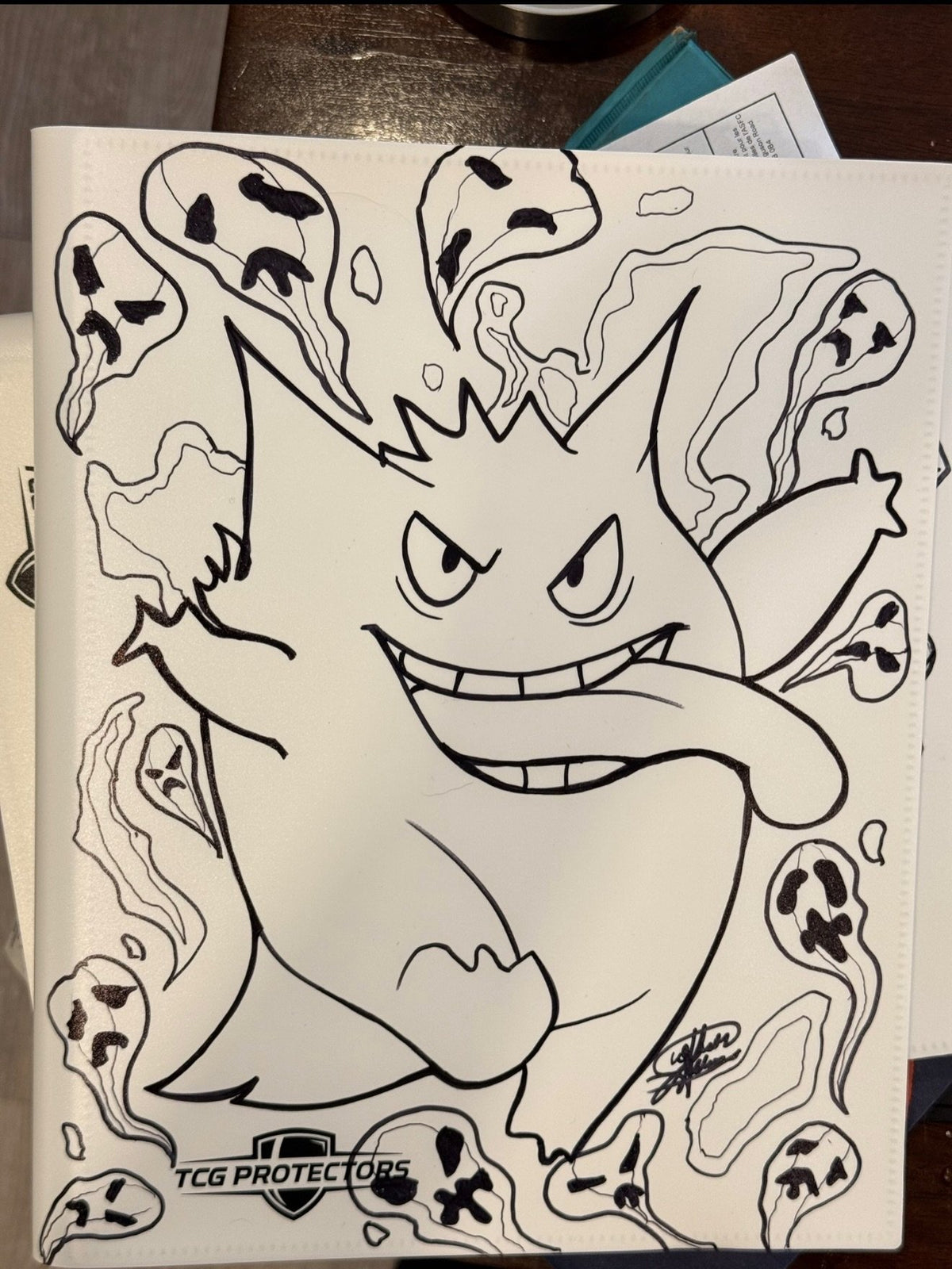 Hand-painted Gengar line-art design on a white TCG Protectors binder