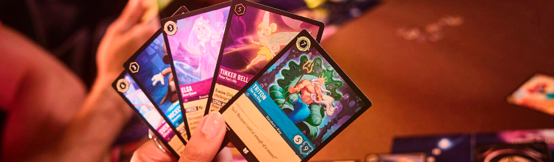 Disney Lorcana cards featuring Mickey Mouse, Gramma Tala, and magical locations fanned out in premium card sleeves for the Race to 20 Lore strategy guide