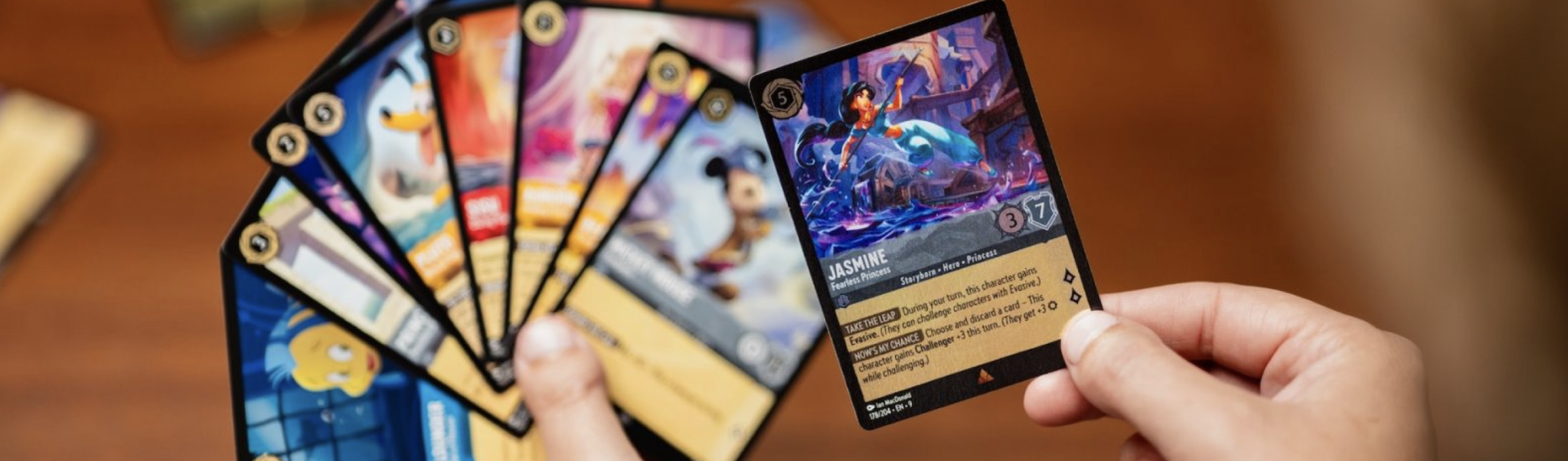 Building Your Lorcana Collection in 2026 – Hand holding a beautiful Jasmine Fearless Princess card from Disney Lorcana TCG.