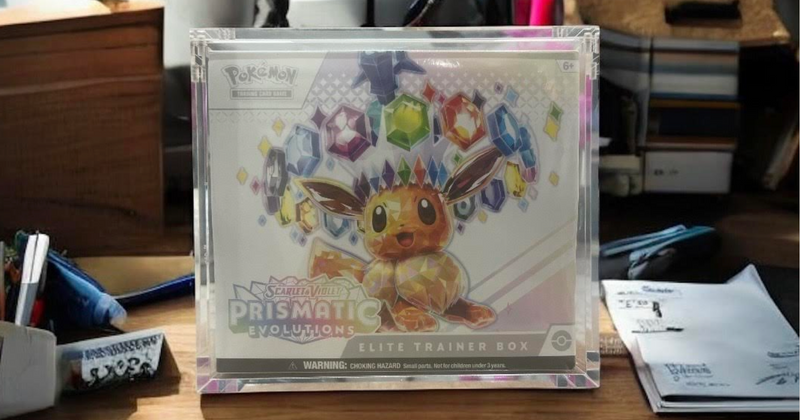 Pokémon Elite Trainer Box Prismatic Evolution secured inside a protective acrylic display case