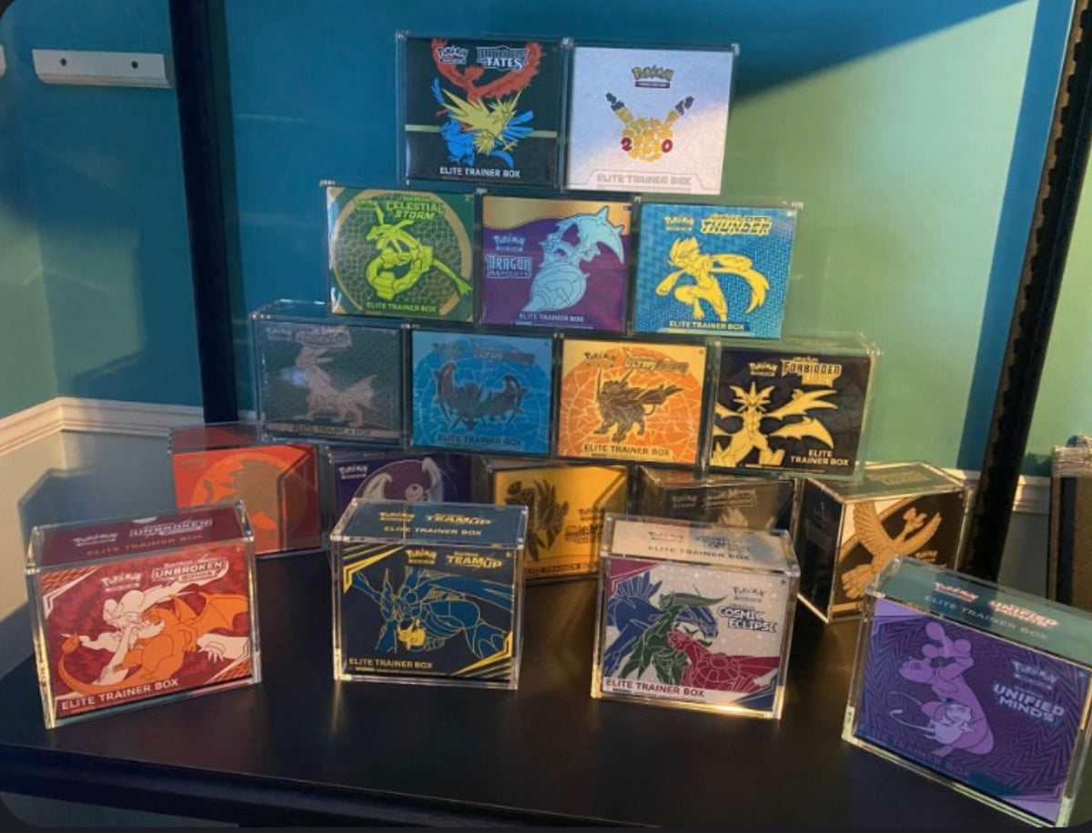 Large collection of ETBs in TCG Protectors acrylic cases