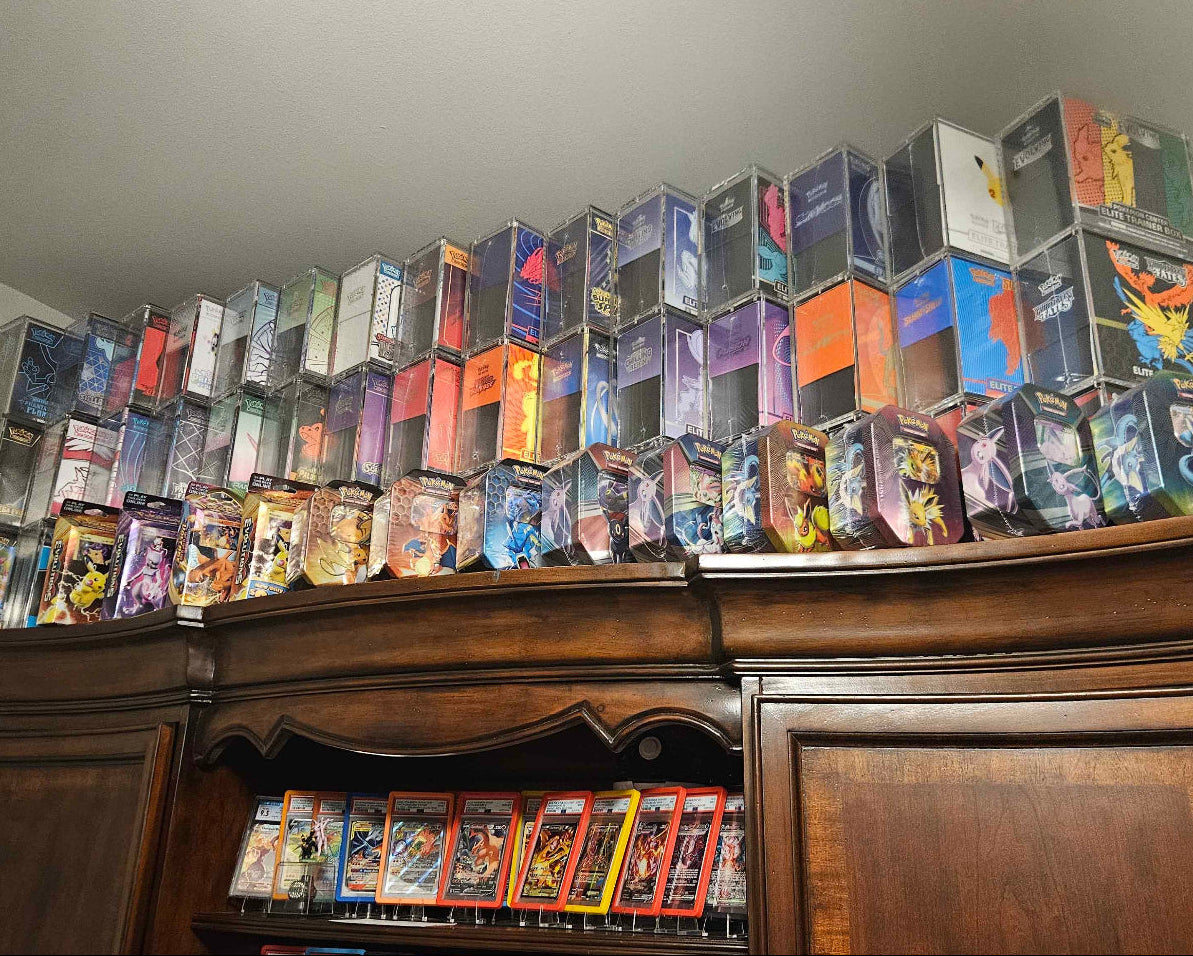 TCG Protectors cases displayed on a wooden shelf