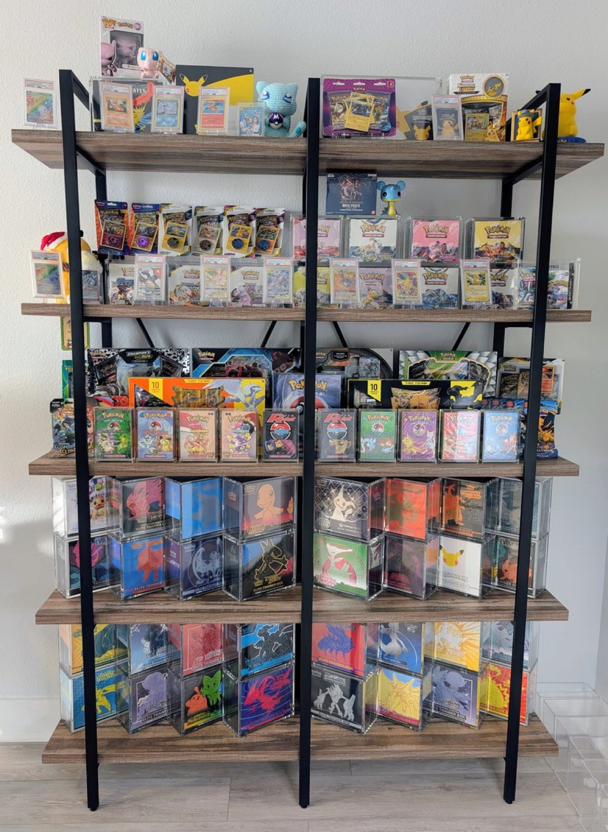 Shelving unit filled with a Pokémon collection in acrylic cases