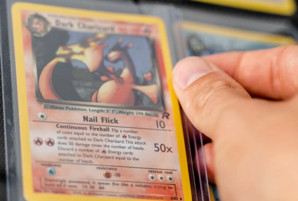 TCG Protectors rigid plastic toploader securing a vintage Dark Charizard Pokémon card stored inside a trading card binder page