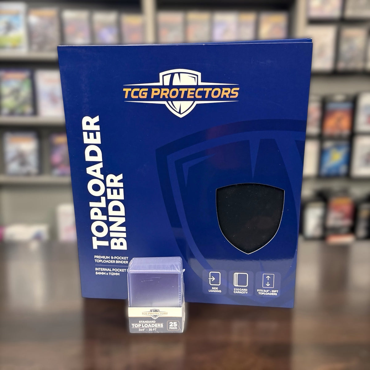 TCG Protectors Toploader Binder and case on a card shop counter